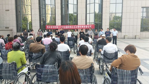 图为商丘市民权县残联开展第三十次全国助残日轮椅发放活动现场